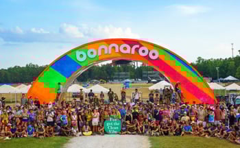 Festival goers posing in front of Bonnaroo Music Festival Arch