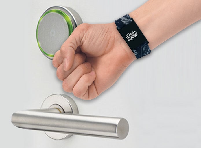 a hotel guest usuing there writband key card to gain acceess to a room