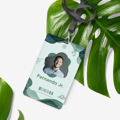 a eco friendly id card and lanyard on a pegboard background with large palm leafs 