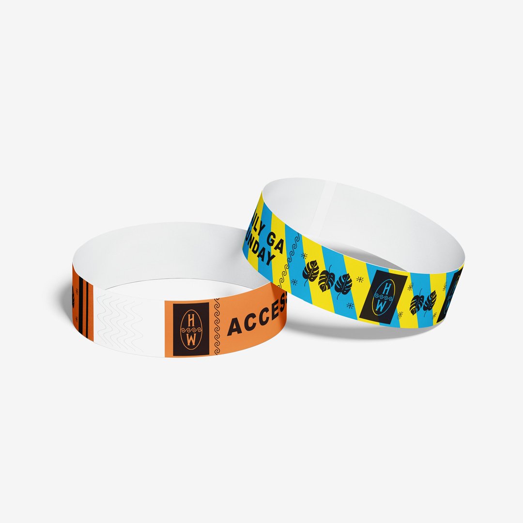 Two Customizable Tyvek Paper Wristbands with logos, text, and artwork printed.