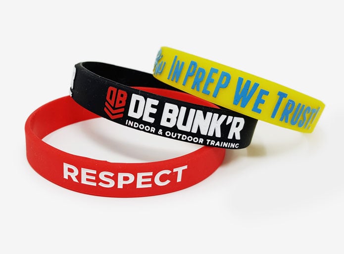 three custom silicone rubber wristbands with diffrent finishes, printed - raised print - sunken print