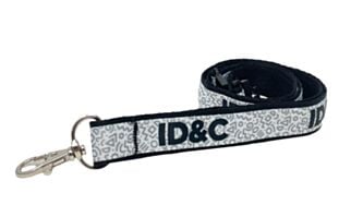 Custom dual-layered premium lanyard with printed recycled polyester top ribbon and metal clip attachment.
