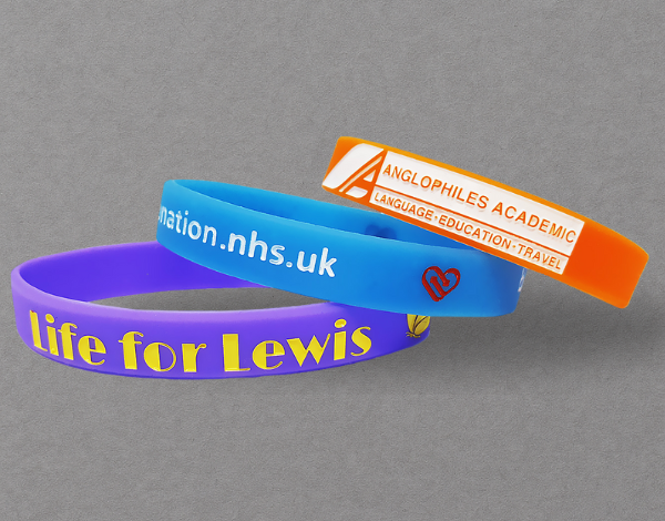 Custom silicone wristbands in blue, purple, and orange with embossed text and logos, designed for long-term use and RFID contactless access