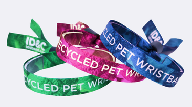 Eco-friendly wristbands made from recycled PET fabric in green, blue, and pink, printed with &ldquo;RECYCLED PET WRISTBAND&rdquo; for sustainable event branding