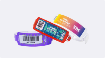 Three colourful vinyl wristbands with barcode labels and snap closures, designed for secure multi-day event use such as waterparks and festivals