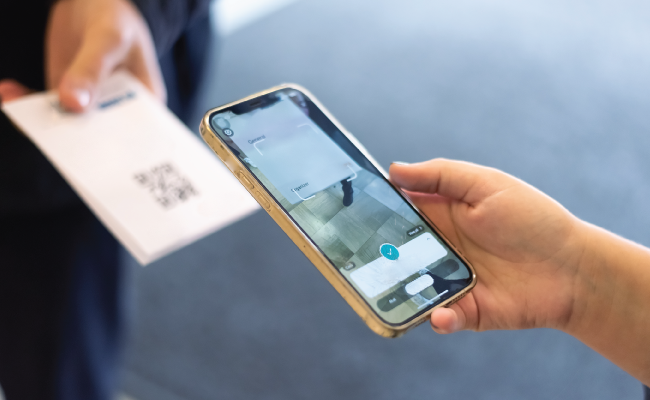 A phone scanning a QR code for a quick event check-in